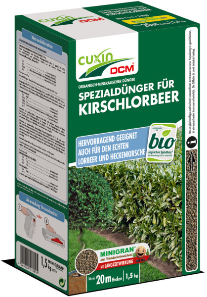 Produktbild von Cuxin DCM Spezialdünger für Kirschlorbeer Minigran in einer 1, 5, kg Streuschachtel mit Informationen über Anwendung und Produkteigenschaften.