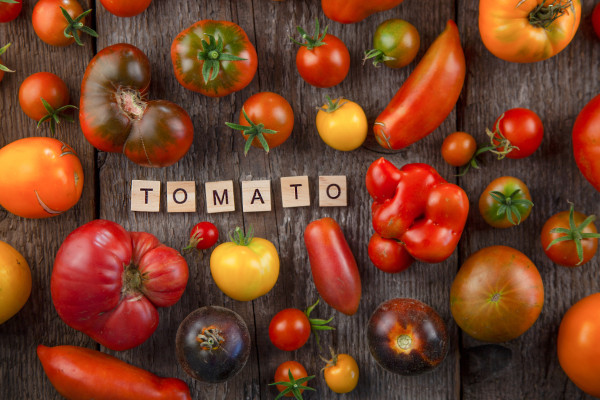 large-colors-on-a-wooden-table-the-word-tomato-in-wooden-letters