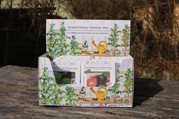 Produktbild der Culinaris BIO Gewaechshaus-Tomaten-Box mit sichtbaren Tomatenpflanzen und Gartenutensilien auf der Verpackung in natürlicher Umgebung.