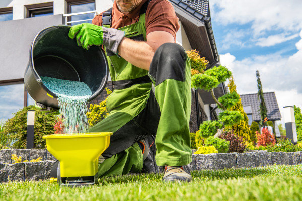 large-garden-worker-preparing-grass-fertilizer
