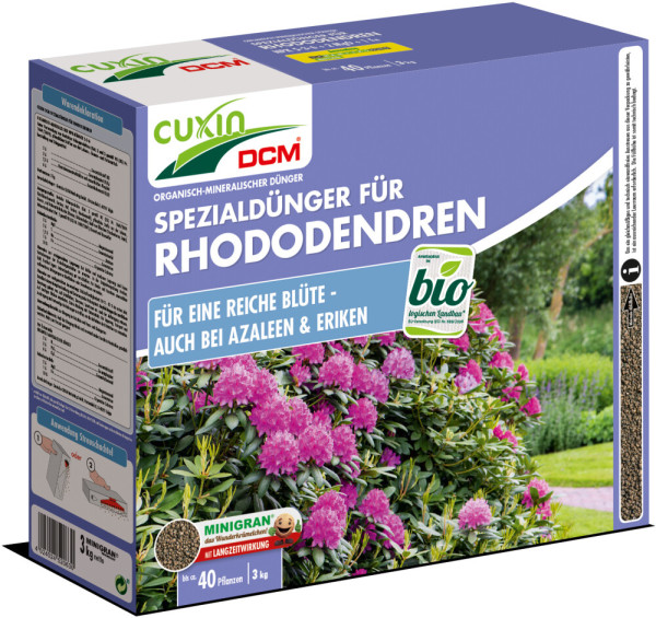 Produktbild von Cuxin DCM Spezialdünger für Rhododendren Azaleen & Eriken Minigran 3kg in einer lila-blauen Streuschachtel mit Markenlogo Informationen zur Anwendung und Bildern von blühenden Pflanzen.