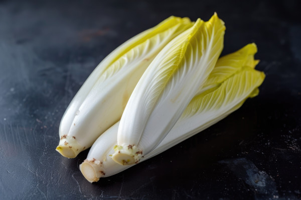 large-ai-generated-fresh-raw-belgian-endives-chicory-on-black-table-closeup